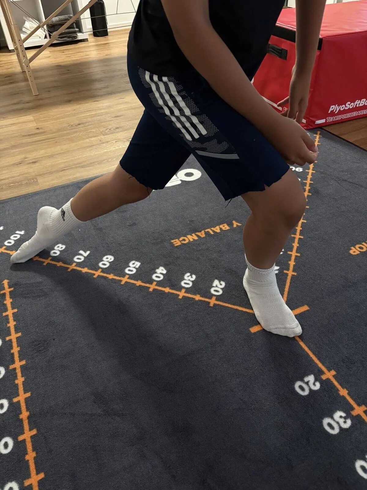 Sportler beim Y-Balance-Test auf der Messmatte